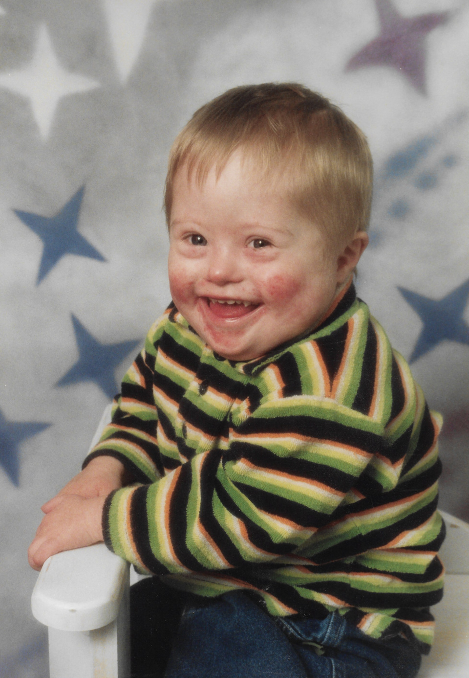 A smiling cheery toddler. Tom was a little boy who just happened to have Down's syndrome