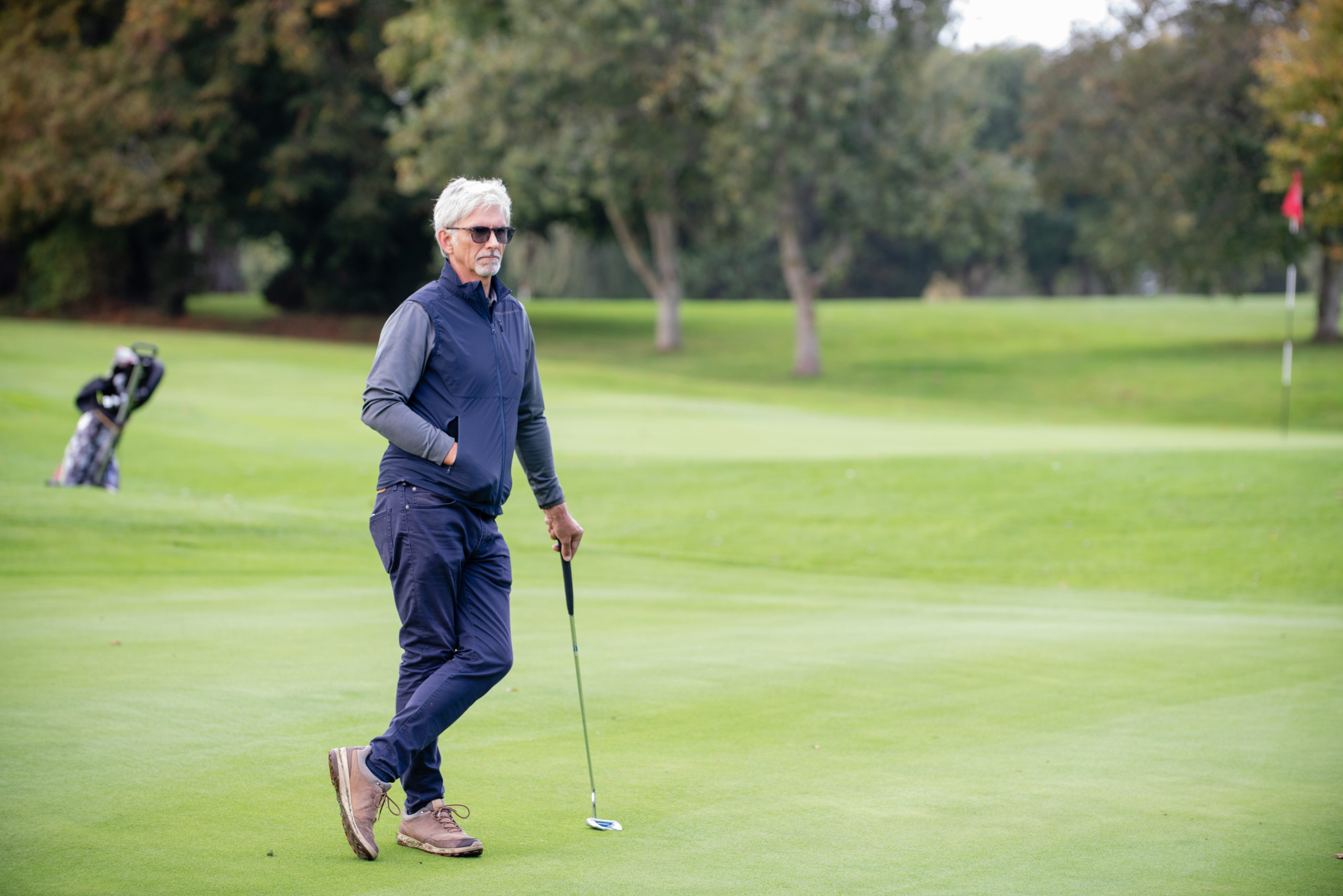 Damon Hill, patron of the DSA, rests between shots on a golf course