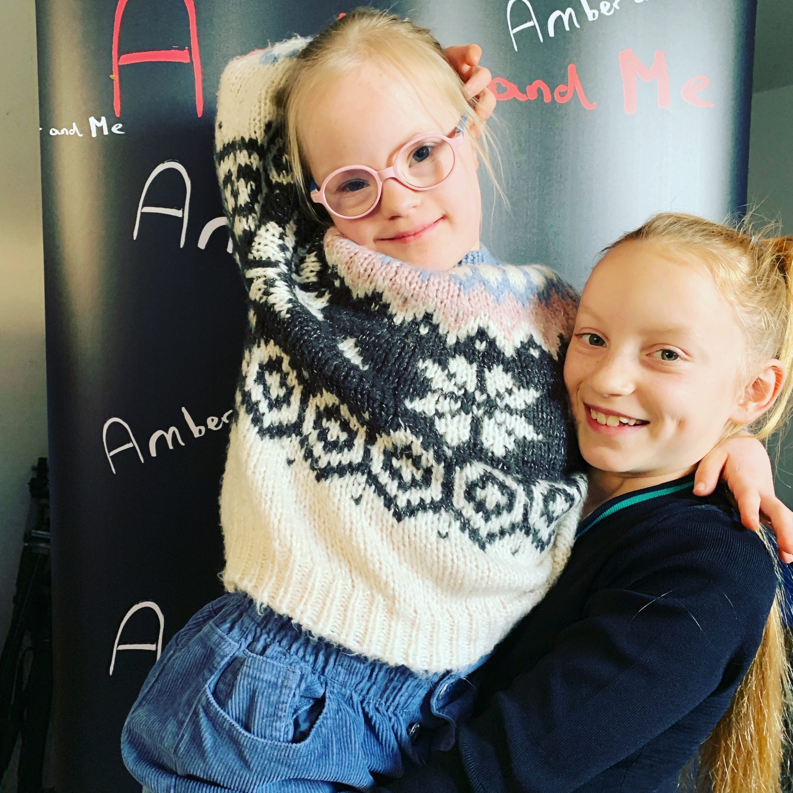 Two sisters hug embrace. One of the sisters has Down's syndrome