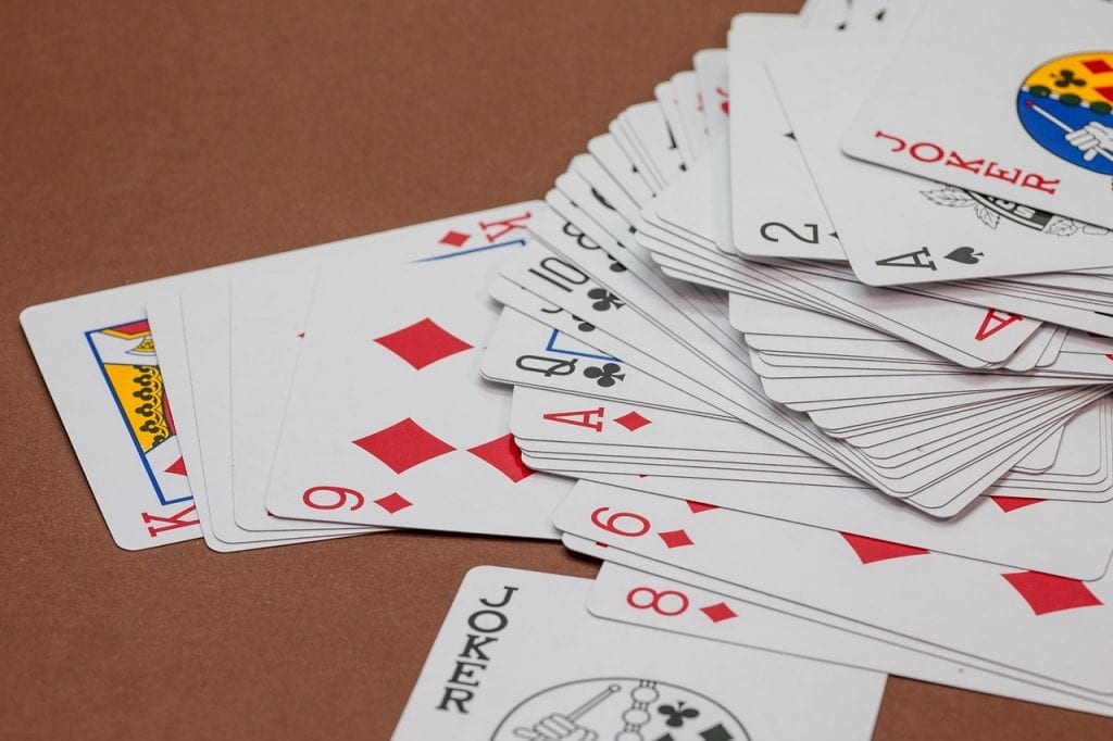 A pack of playing cards spread across a table