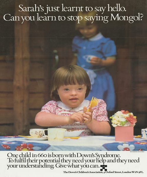A campaigning poster from the DSA from the '80s. The picture is of a little girl in a floral dress playing with a dolls tea set. The caption says 'Sarah's just learnt to say hello. Can you learn to stop saying Mongol?'