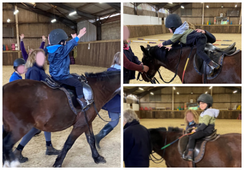 A young boy who has Down's syndrome enjoying a horseriding lesson