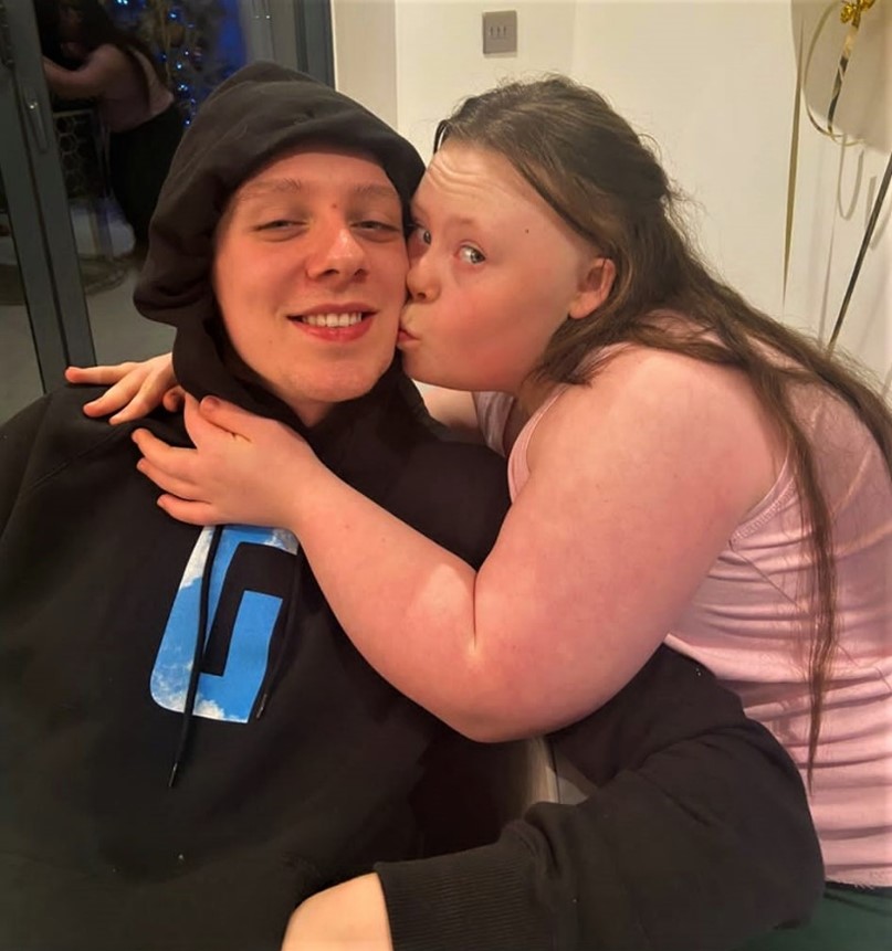 A picture of Aitch's sister Grace giving him a kiss on the cheek.