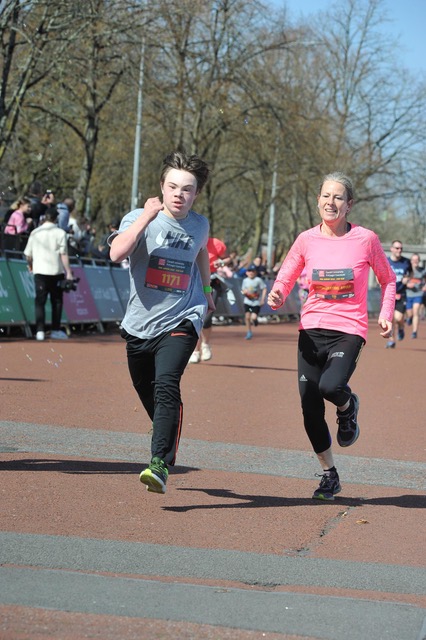 A young man and woman running in a marathon