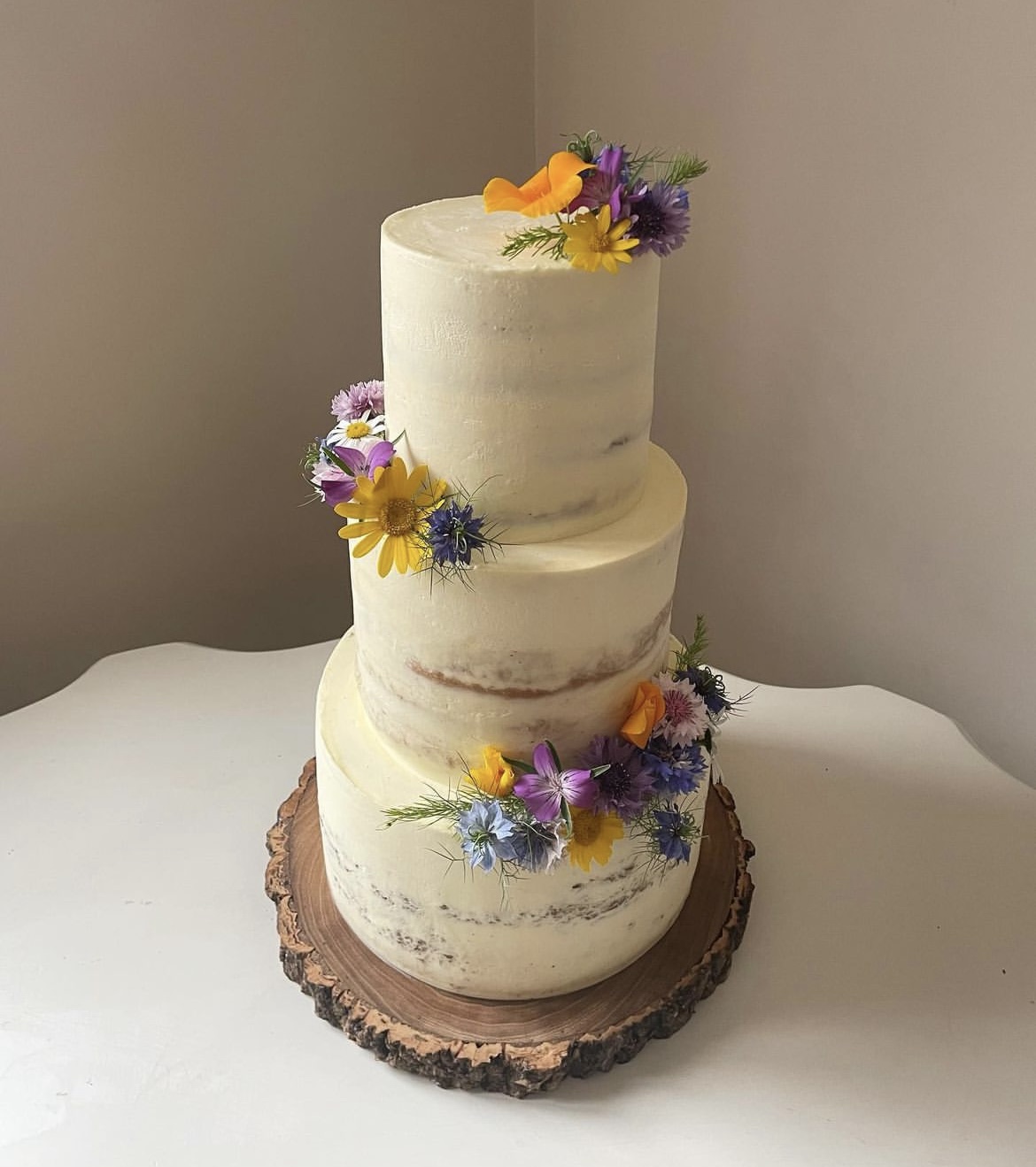 3 tier wedding cake decorated with sugar flowers